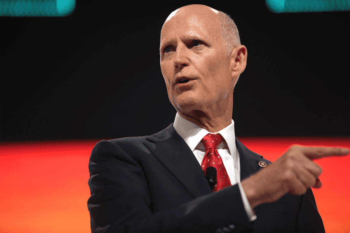 U.S. Senator Rick Scott speaking with attendees at the 2021 Student Action Summit hosted by Turning Point USA at the Tampa Convention Center in Tampa, Florida (Gage Skidmore).