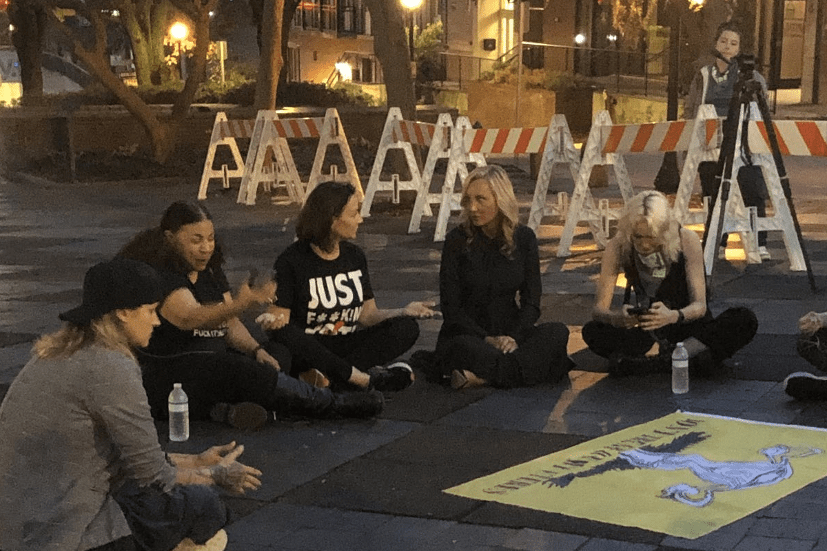 Protestors, including Florida Democratic Party Chair Nikki Fried and Senate Democratic Leader Lauren Book sit down outside City Hall, Tallahassee, Fla., April 4, 2023. (Photo/Gary Fineout, Twitter)