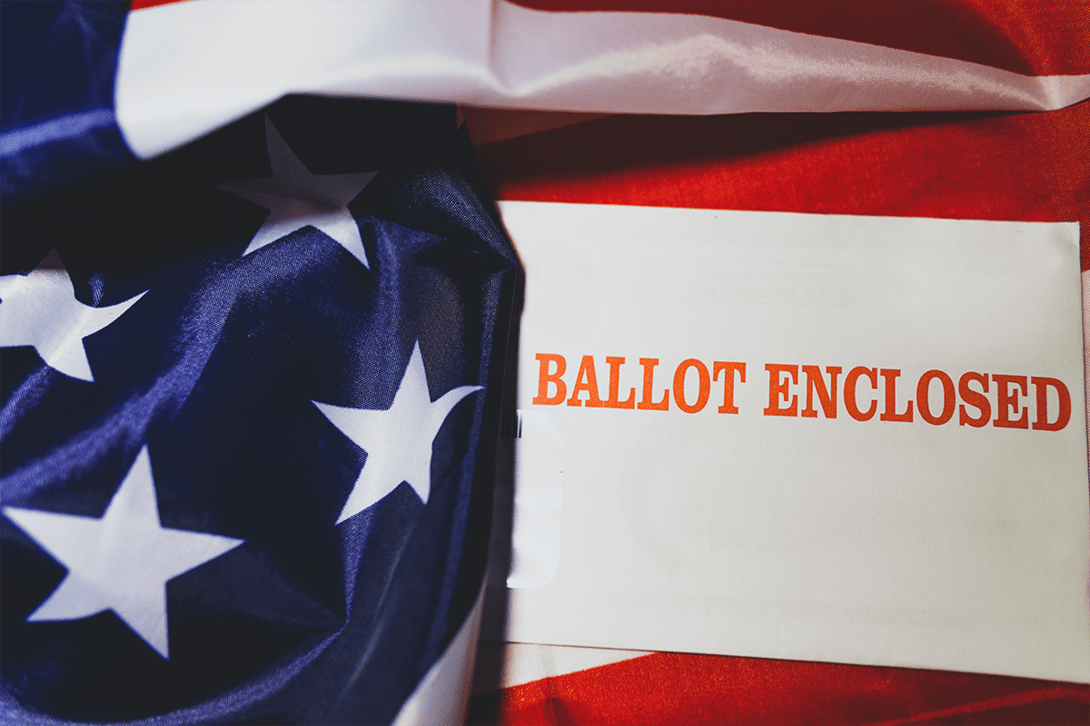 Mail-in ballot in American flag, Nov. 4, 2020. (Photo/Joshua Woroniecki, Unsplash)