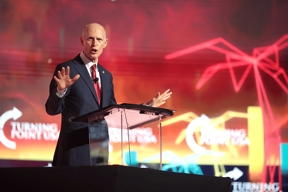 <a href=https://www.flickr.com/photos/gageskidmore/52252369975>U.S. Sen. Rick Scott, R-Fla., speaking with attendees at the 2022 Student Action Summit at the Tampa Convention Center in Tampa, Fla., July 23, 2022.</a> (Photo/Gage Skidmore, Flickr)