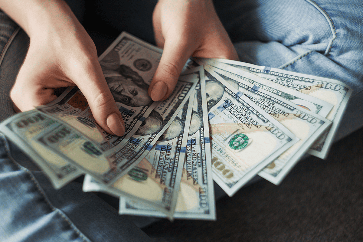 American $100 bills, March 27, 2019. (Photo/Alexander Mils, Unsplash)