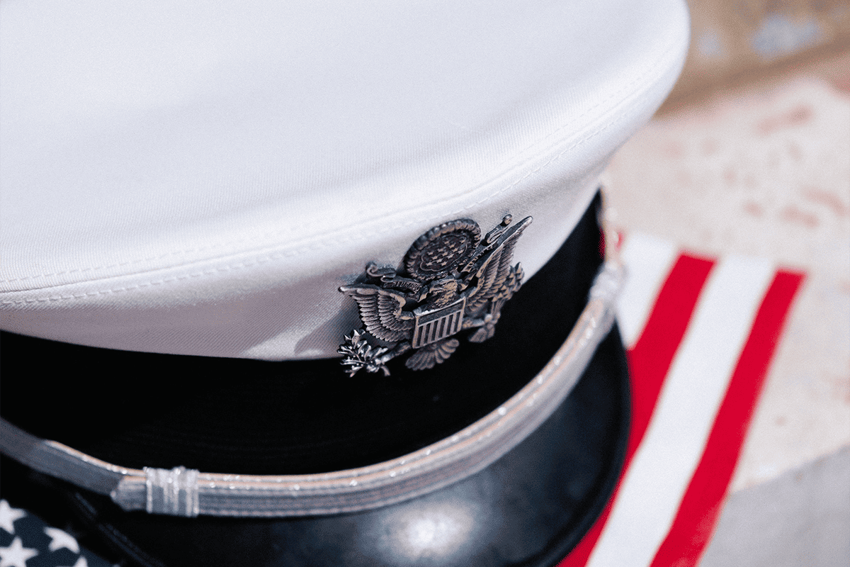 U.S. Air Force service cap and an American flag, April 27, 2023. (Photo/Wesley Tingey, Unsplash)
