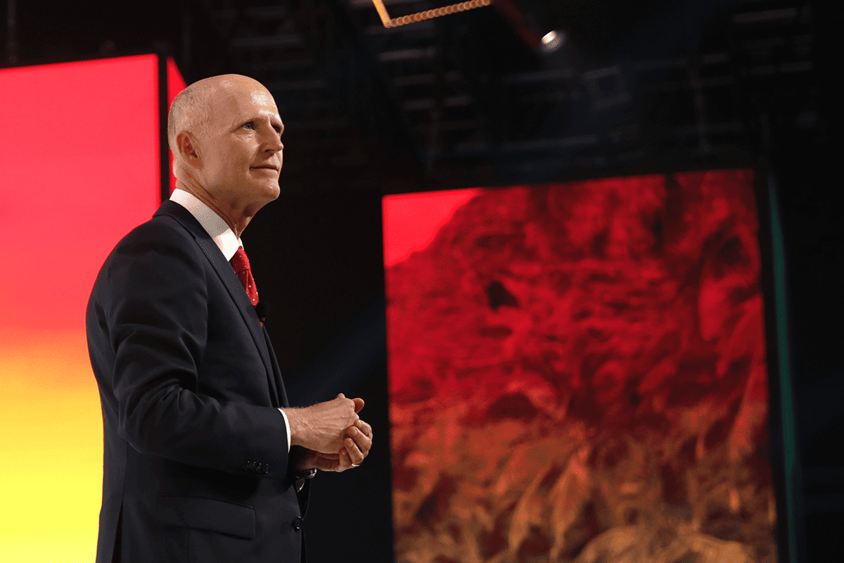 <a href=https://www.flickr.com/photos/gageskidmore/51327019309>U.S. Sen. Rick Scott, R-Fla., peaking with attendees at the 2021 Student Action Summit hosted by Turning Point USA at the Tampa Convention Center in Tampa, Fla., July 17, 2021.</a> (Photo/Gage Skidmore, Flickr)