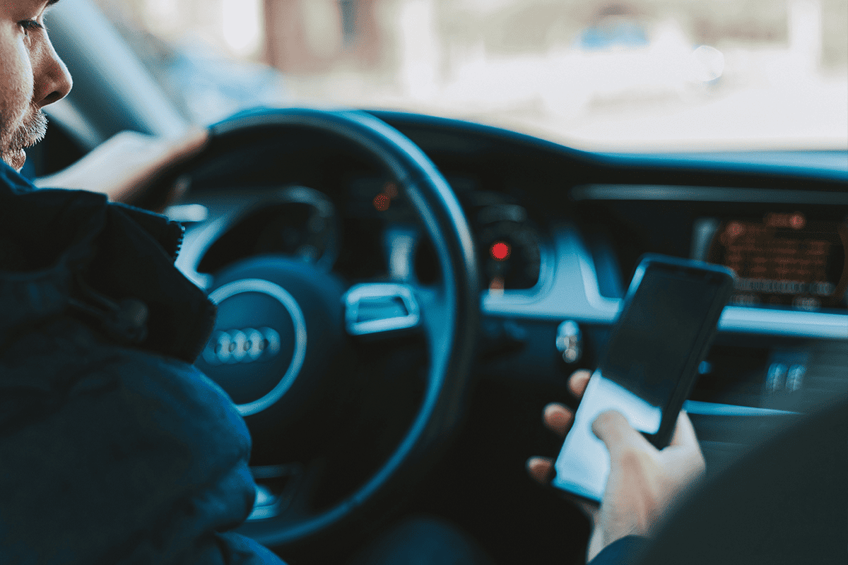 Man using his smartphone in the car, March 3, 2018. (Photo/Alexandre Boucher, Unsplash)